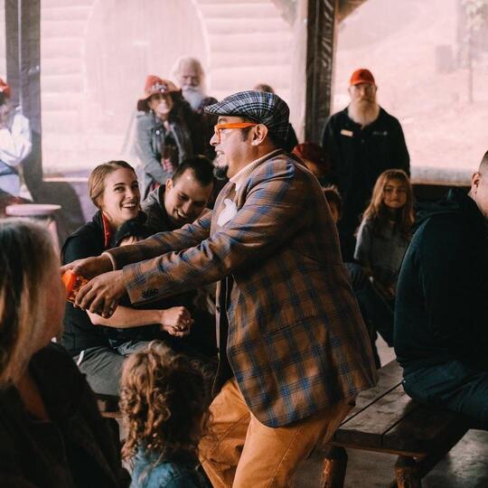 Wacko engaging with the audience in a plaid suit
