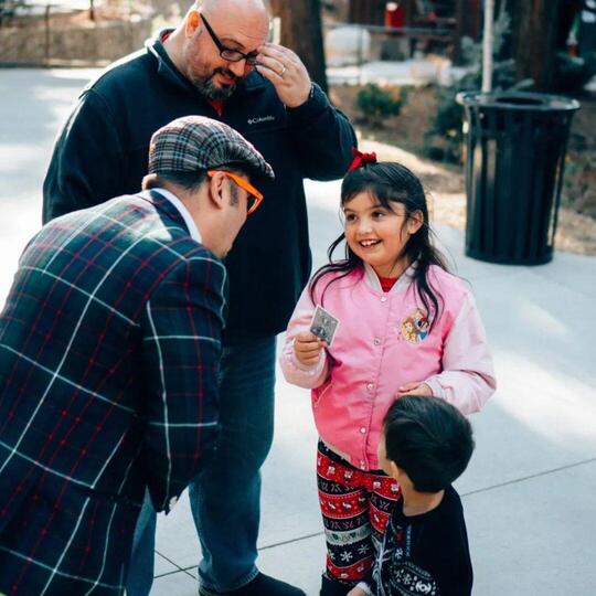 Wacko talking to a happy young girl and her family